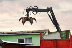 Magnet grapple picking up iron and steel metal garbage for trans